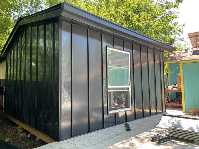 Black standing seam metal wall panels for Roof Inspection in Wixom