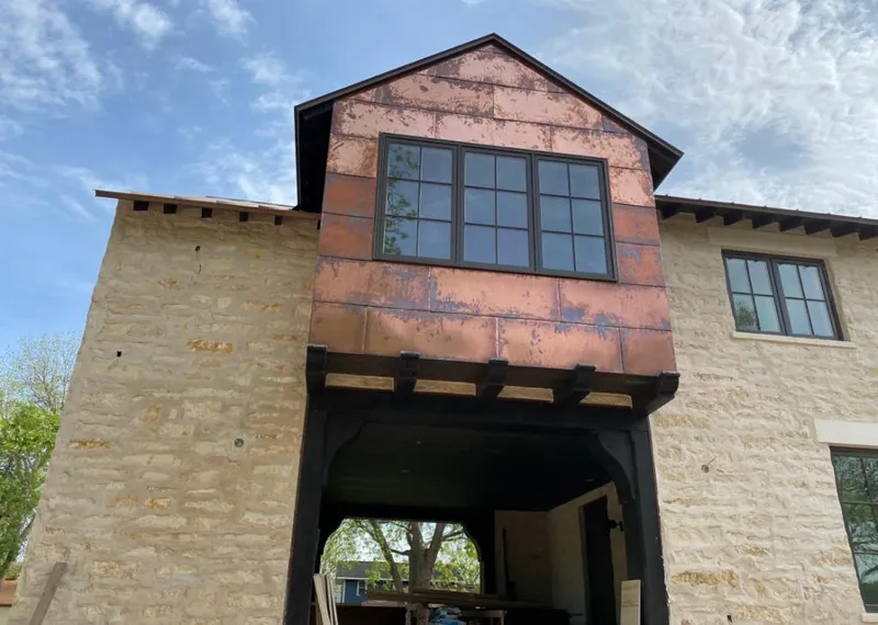 Copper metal panel facade on a stone building for Roof Repair in Wixom